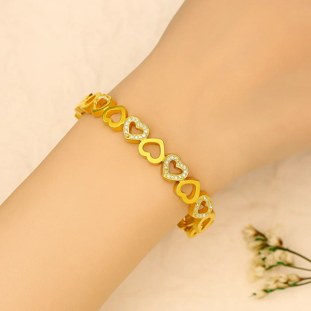 Gold heart bracelet with crystal accents on wrist, stylish anti-tarnish jewelry for women