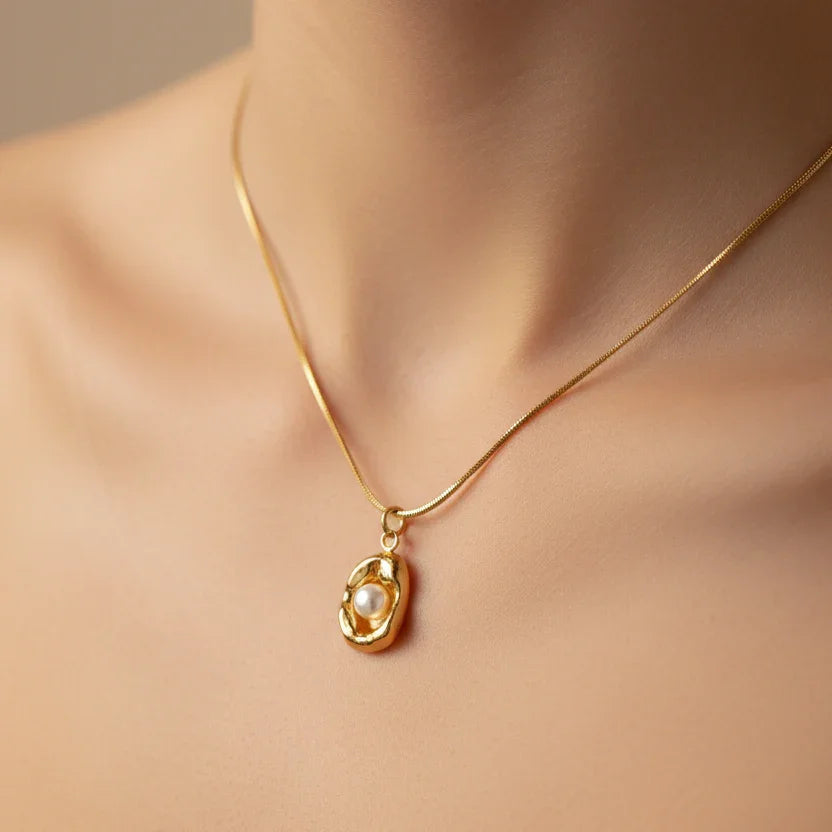Gold necklace with organic pearl pendant on woman's neck, premium anti-tarnish jewelry