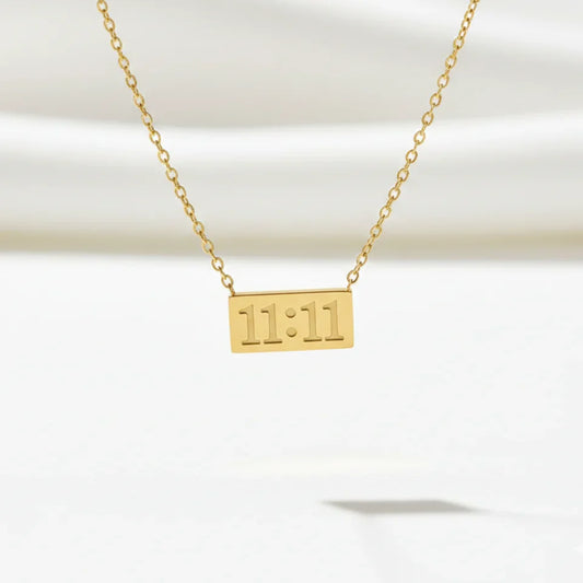 Gold chain necklace with rectangular 11:11 engraved pendant, minimalist jewelry.