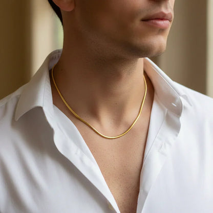 Man wearing a gold chain necklace with open white shirt, premium anti-tarnish jewelry