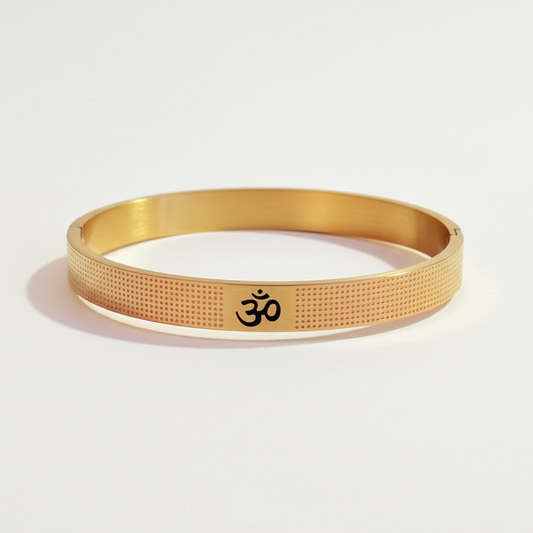 Gold anti-tarnish bracelet with Om symbol and textured design on white background