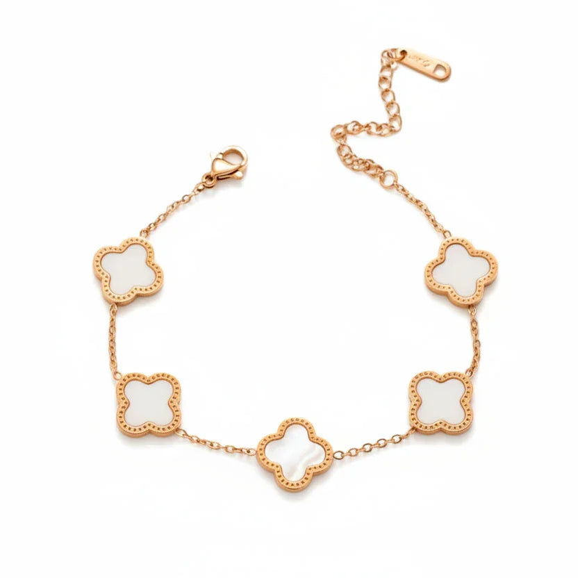 Gold bracelet with white clover-shaped charms on delicate chain, minimalist jewelry